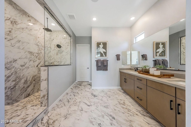 bathroom featuring vanity and tiled shower