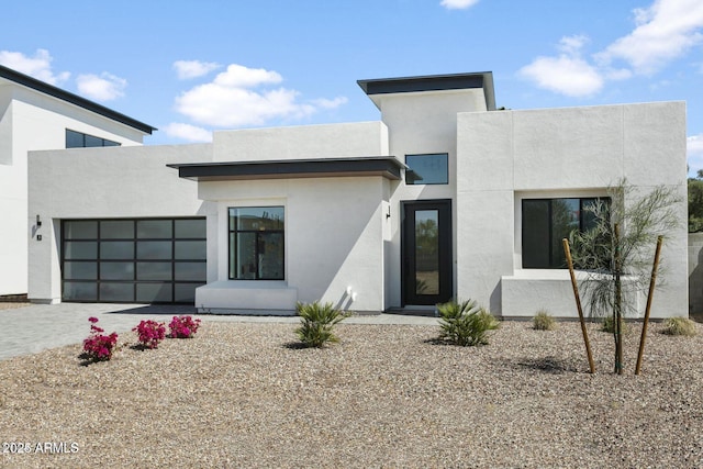 100 W Northern Ave Unit 17, Phoenix, AZ 85021 - view of front of house featuring a garage, decorative driveway, and stucco siding