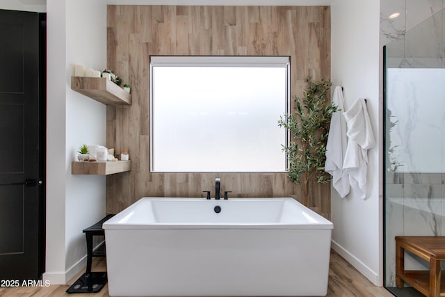 100 W Northern Ave Unit 17, Phoenix, AZ 85021 - bathroom with a soaking tub, baseboards, and wood finished floors