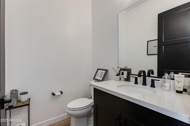 100 W Northern Ave Unit 17, Phoenix, AZ 85021 - bathroom featuring baseboards, vanity, toilet, and wood finished floors