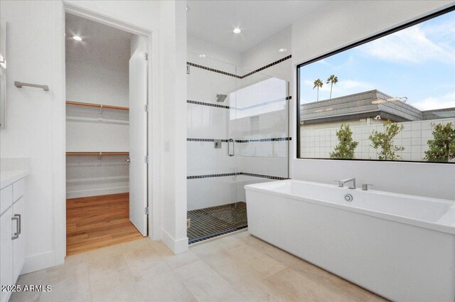 100 W Northern Ave Unit 17, Phoenix, AZ 85021 - bathroom featuring recessed lighting, a soaking tub, a spacious closet, a stall shower, and vanity