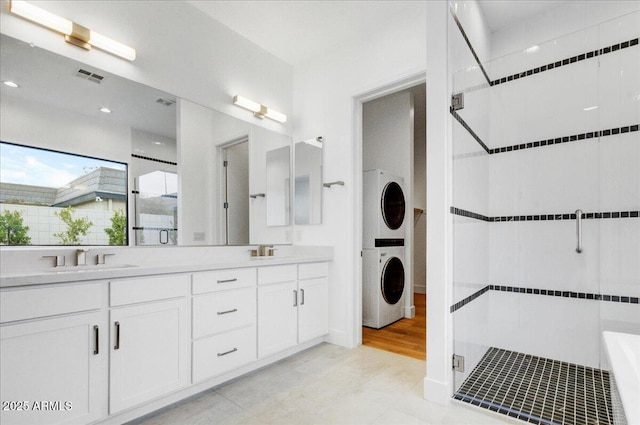 100 W Northern Ave Unit 17, Phoenix, AZ 85021 - bathroom featuring stacked washer and dryer, a sink, visible vents, and a shower stall