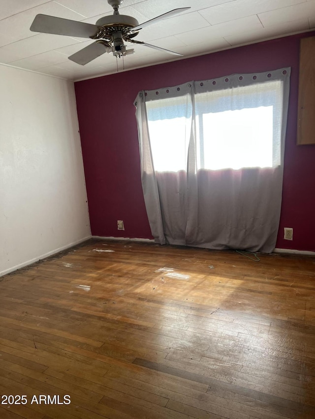spare room with wood-type flooring and a healthy amount of sunlight