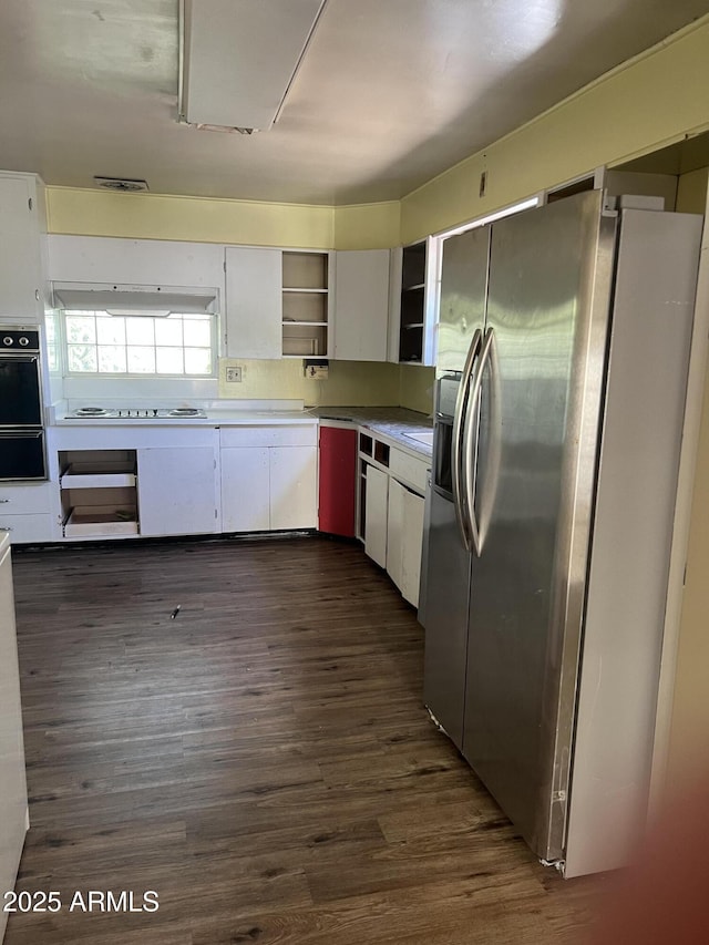 kitchen with open shelves, electric cooktop, oven, stainless steel fridge with ice dispenser, and dark wood finished floors