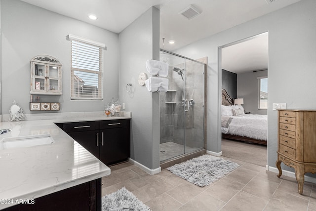 bathroom with walk in shower, vanity, and a wealth of natural light