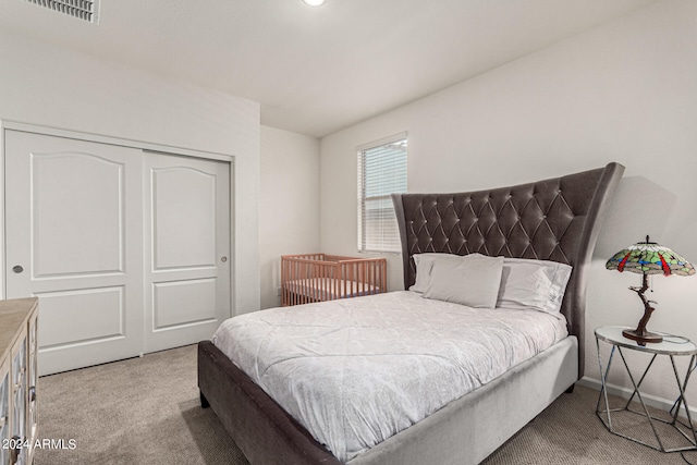 carpeted bedroom with a closet