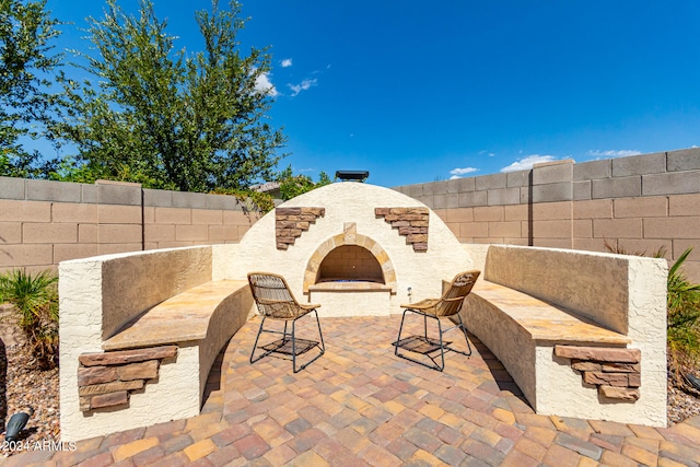 view of patio / terrace featuring exterior fireplace