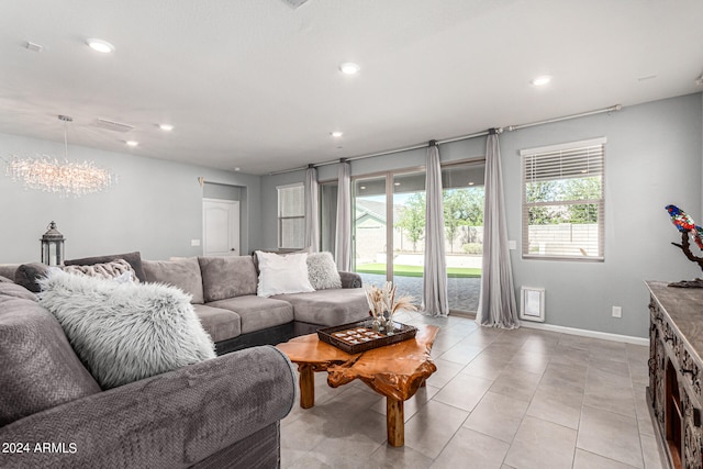 living room featuring a chandelier and light tile patterned flooring