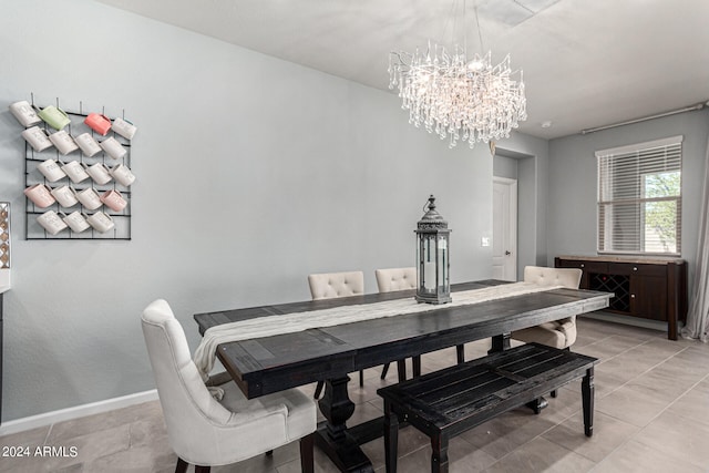 dining area with a notable chandelier and light tile patterned floors