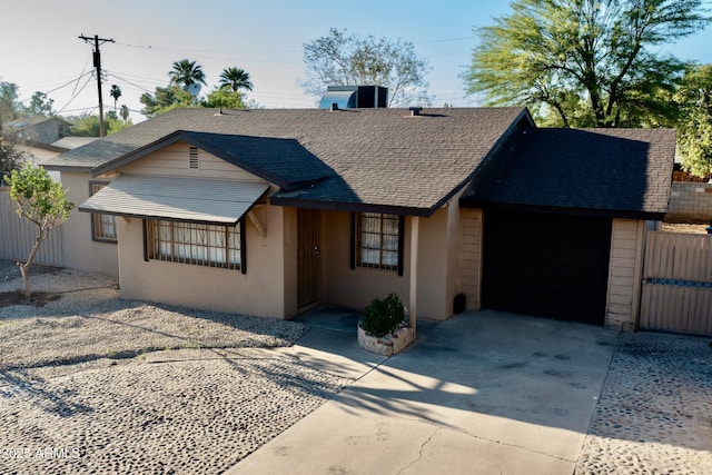 1914 W Colter St, Phoenix, AZ 85015 - view of front of property featuring stucco siding, driveway, a garage, fence, and a shingled roof