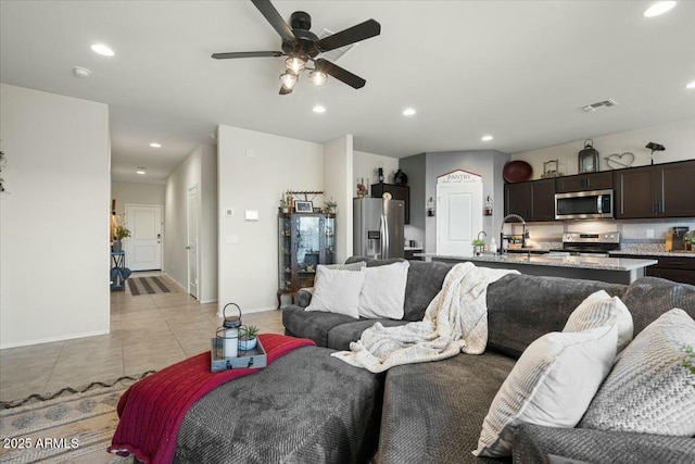 tiled living room with sink and ceiling fan