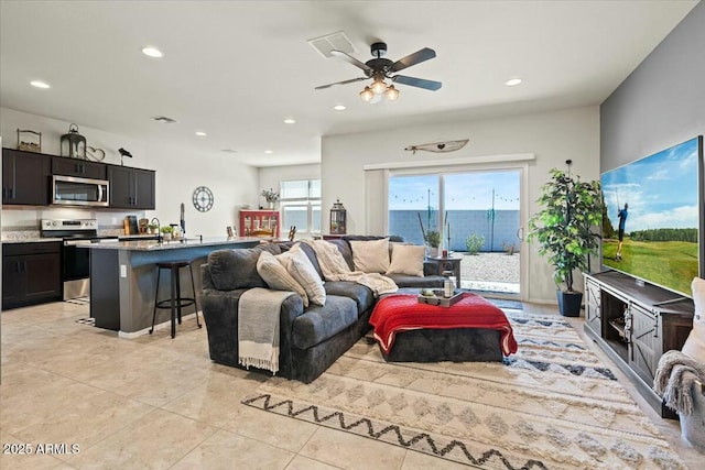 tiled living room with ceiling fan