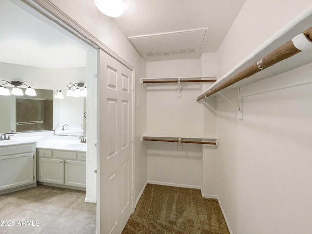 spacious closet featuring a sink and visible vents