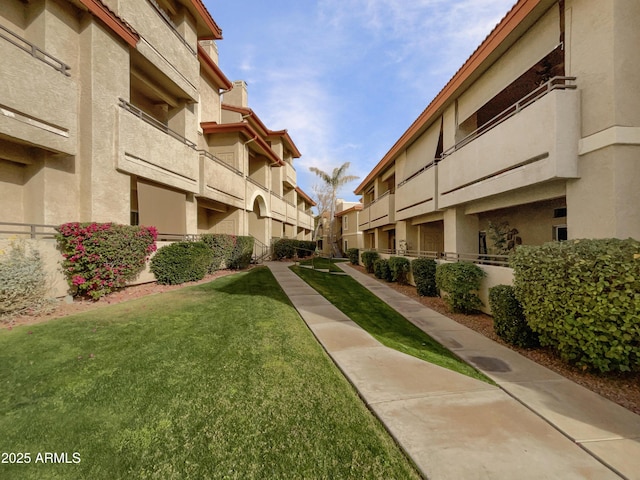 view of property's community with a lawn