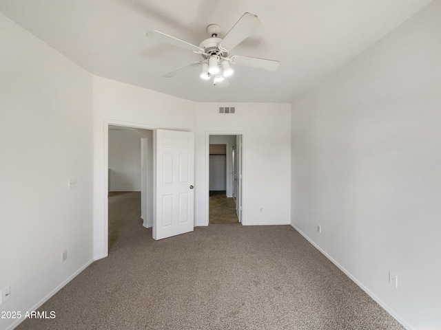 unfurnished bedroom with a ceiling fan, baseboards, visible vents, and carpet flooring