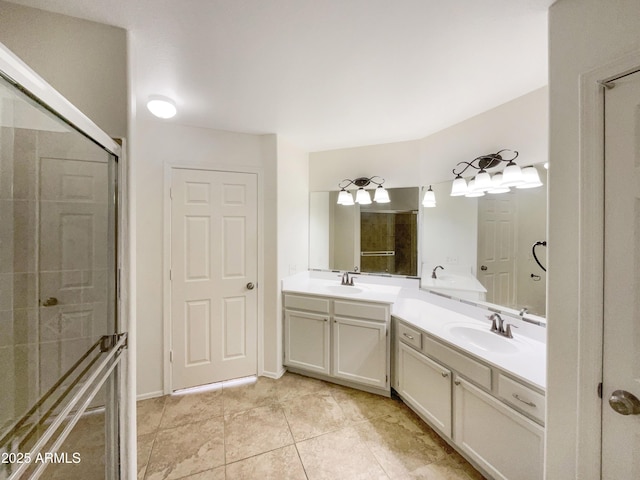 full bath with double vanity, tile patterned flooring, a sink, and a shower with shower door