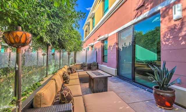 view of patio / terrace with an outdoor living space with a fire pit