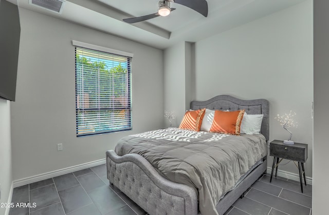 bedroom with dark tile patterned floors and ceiling fan