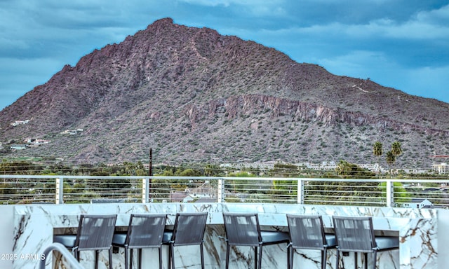 exterior space with a balcony and a mountain view