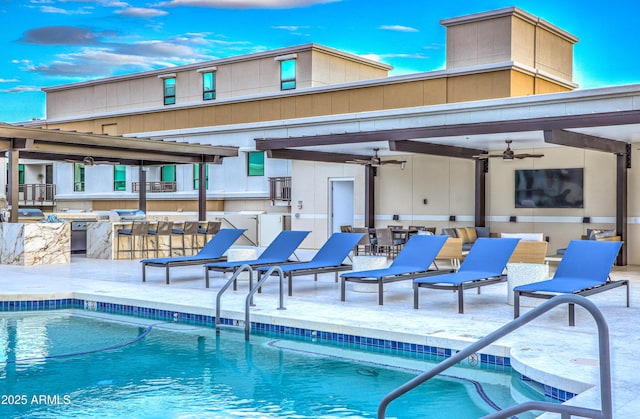 snow covered pool featuring a bar, ceiling fan, a grill, and a patio