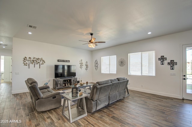 living room featuring dark hardwood / wood-style floors and ceiling fan