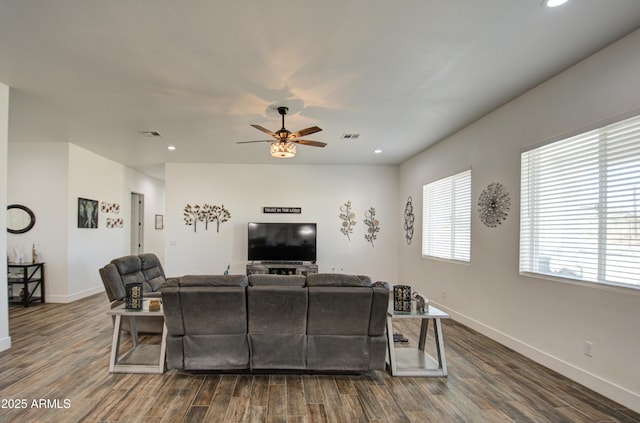 living room with dark hardwood / wood-style floors and ceiling fan