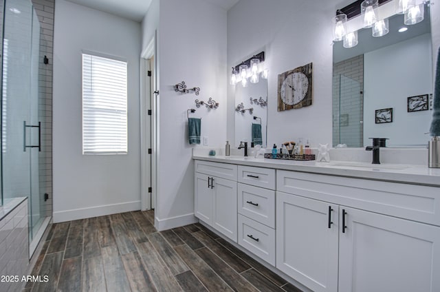 bathroom featuring walk in shower and vanity