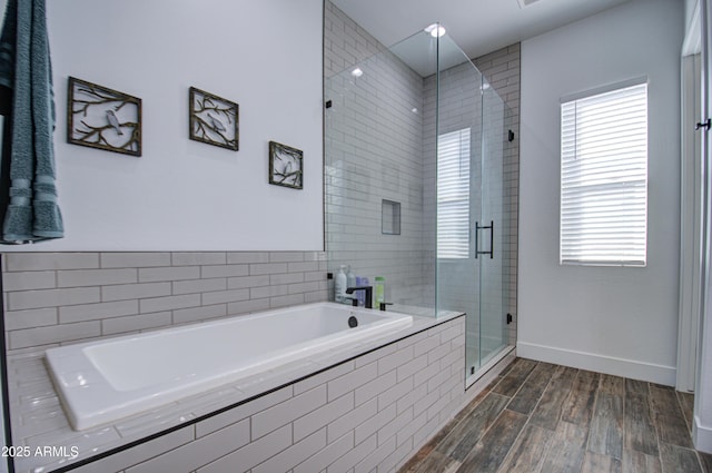 bathroom featuring hardwood / wood-style floors and plus walk in shower