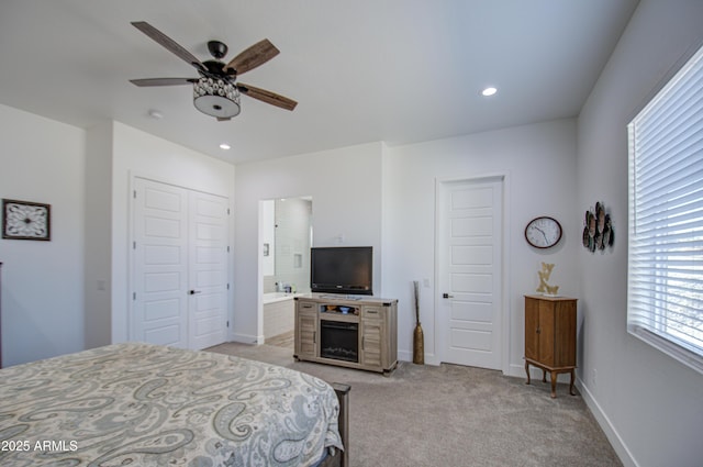 carpeted bedroom featuring ceiling fan, connected bathroom, and a closet