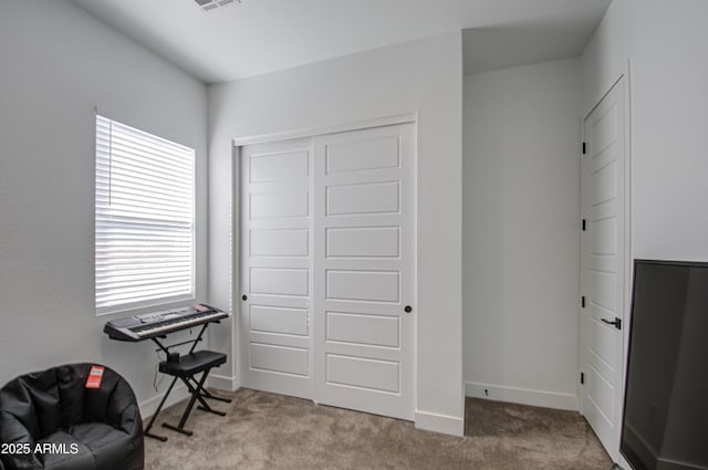 living area with light colored carpet