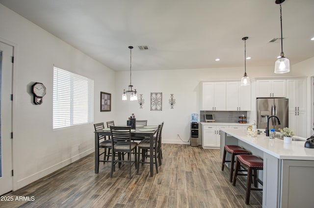 dining room featuring dark wood-type flooring and sink