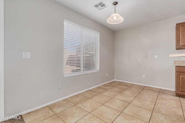 unfurnished dining area featuring light tile patterned flooring