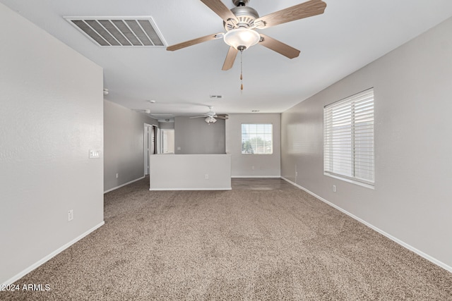 empty room featuring carpet flooring and ceiling fan