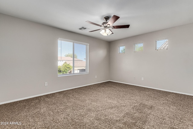 carpeted spare room featuring ceiling fan