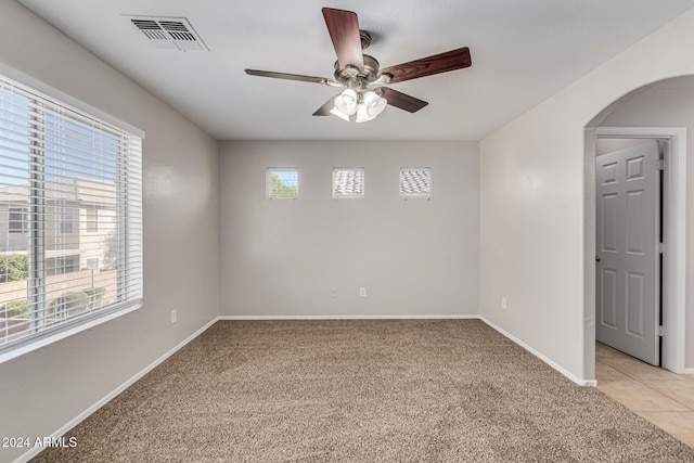 spare room with light colored carpet and plenty of natural light