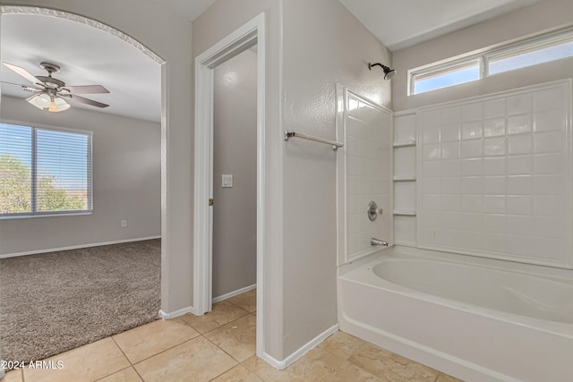 bathroom with ceiling fan,  shower combination, and tile patterned flooring