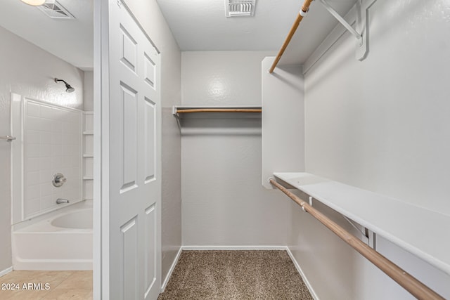 spacious closet with light colored carpet