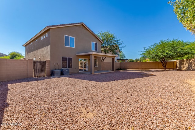 rear view of house featuring a patio area and cooling unit