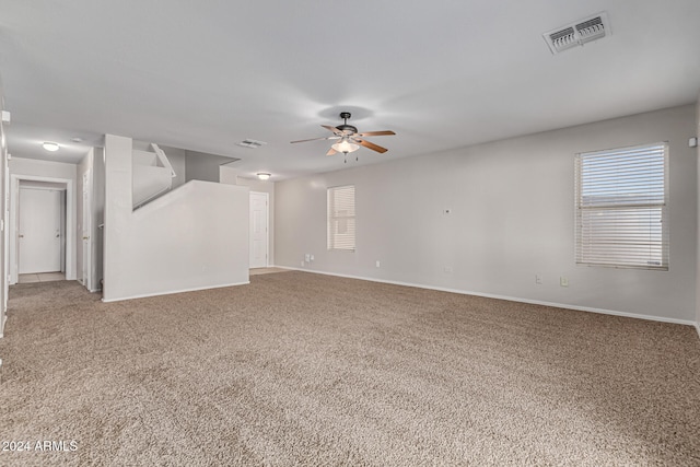 unfurnished living room with carpet and ceiling fan