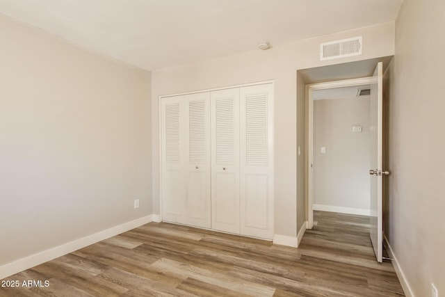 9622 N 35th Ln, Phoenix, AZ 85051 - unfurnished bedroom featuring wood finished floors and a closet