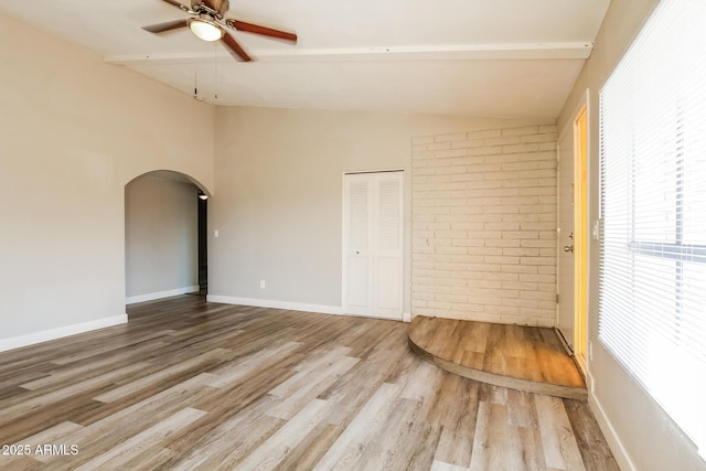 9622 N 35th Ln, Phoenix, AZ 85051 - unfurnished room with vaulted ceiling, arched walkways, wood finished floors, a ceiling fan, and healthy amount of natural light