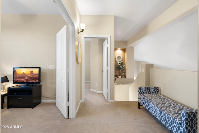 bedroom featuring lofted ceiling with beams and light colored carpet