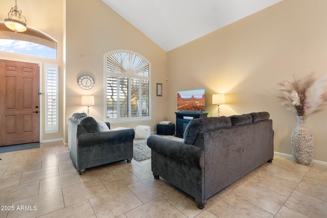 living room featuring high vaulted ceiling and light tile patterned floors