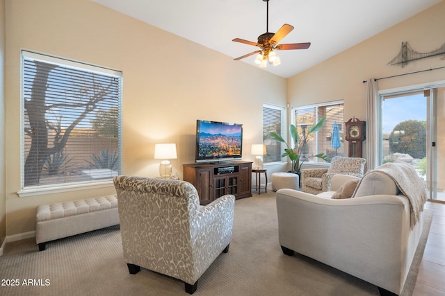 carpeted living room featuring ceiling fan and vaulted ceiling