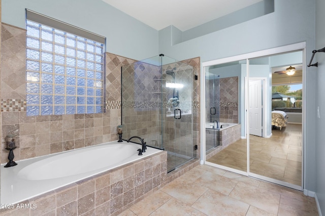 bathroom featuring tile patterned floors and separate shower and tub