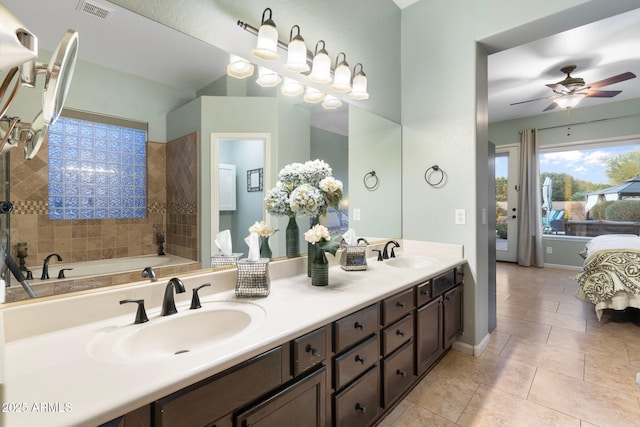 bathroom with ceiling fan, vanity, tile patterned flooring, and a bathtub