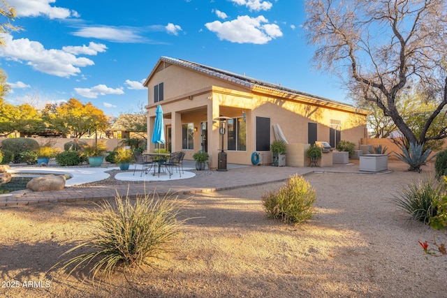 back of house with a patio