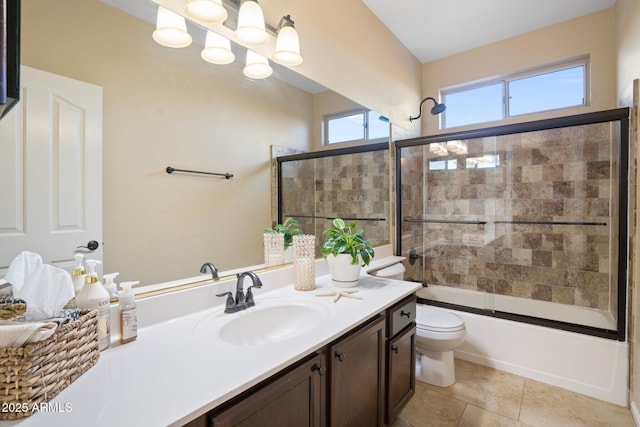 full bathroom featuring vanity, tile patterned flooring, toilet, and combined bath / shower with glass door