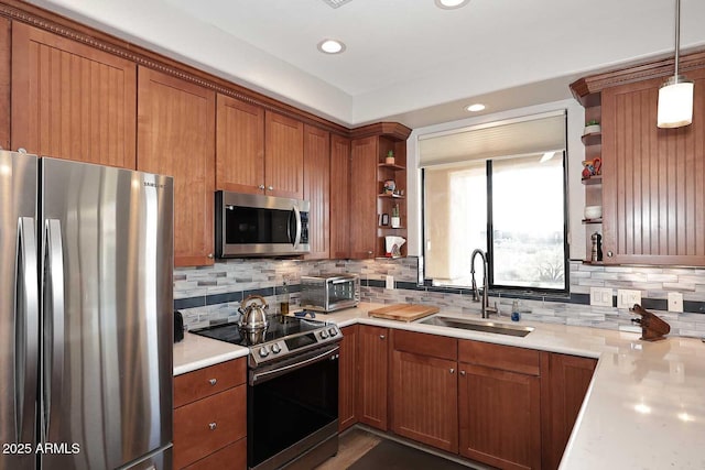 kitchen featuring pendant lighting, stainless steel appliances, tasteful backsplash, and sink