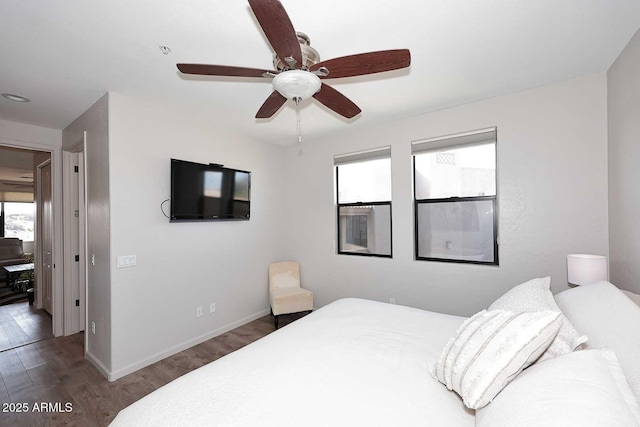 bedroom featuring ceiling fan and dark hardwood / wood-style floors